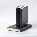 Three hardcover books with plain black covers are displayed against a plain white Royalty Free Stock Photo