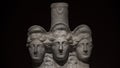 Three headed roman-asian ancient statue of beautiful women at bl