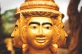 Three heads of golden Buddha statue in monesary in Siem Reap, Cambodia