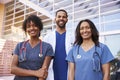 Three healthcare colleagues standing outside modern hospital Royalty Free Stock Photo