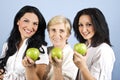 Three healthy beauty women giving you apples