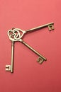 Three heart shape gold keys - vertical. Royalty Free Stock Photo
