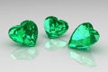 Three heart shape green emerald gemstones