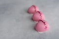 Three heart-shaped pink cakes with mirrored glaze