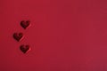 Three hearts, blank Valentine's Day greeting card. Red monochrome romantic background. Royalty Free Stock Photo