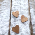 Three hearts with inscriptions of love on the background of the boards is not the background of snow, Valentine`s day