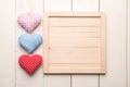 Three hearts on wood background