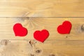 Three hearts on the wooden background. red hearts on gray old wood Royalty Free Stock Photo