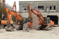 Three heavy excavators during a redevelopment work of urban area.