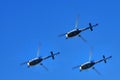 Three helicopters in the blue sky
