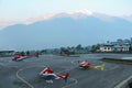 Three helicopters on the runway at dawn in Himalayas