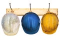 Three helmets hanging on a hat-rack Royalty Free Stock Photo