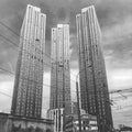 Three high-rise buildings on the background of the old plant