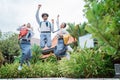 three high school students jumping high wearing school bags raising their hands together