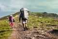 Three hikers walking in the mountains