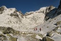 Three hikers in red clothes in winter Tatra mountains