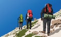 Three hikers trekkers of backpackers with a big backpacks on his back