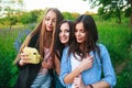 Three hipsters girls blonde and brunette taking self portrait on polaroid camera and smiling outdoor. Girls having fun together Royalty Free Stock Photo