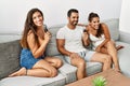 Three hispanic friends smiling happy singing song using microphone at home Royalty Free Stock Photo