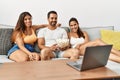 Three hispanic friends watching film using laptop home Royalty Free Stock Photo