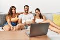 Three hispanic friends watching film using laptop home Royalty Free Stock Photo