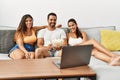 Three hispanic friends watching film using laptop home Royalty Free Stock Photo