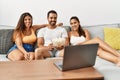 Three hispanic friends watching film using laptop home Royalty Free Stock Photo