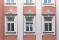 Three historic windows with stucco ornate above