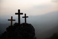 The three holy crosses of Jesus Christ shining through the red sky and clouds and bright rays background. Silhouette cross on Royalty Free Stock Photo