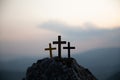 The three holy crosses of Jesus Christ shining through the red sky and clouds and bright rays background. Silhouette cross on Royalty Free Stock Photo