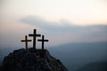 The three holy crosses of Jesus Christ shining through the red sky and clouds and bright rays background. Silhouette cross on Royalty Free Stock Photo