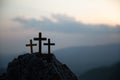 The three holy crosses of Jesus Christ shining through the red sky and clouds and bright rays background. Silhouette cross on Royalty Free Stock Photo