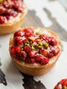 Three homemade mini-cheesecake with wild strawberries