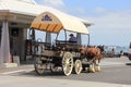 Three horses with a carriage and coachman