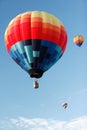 Three hot air balloons at a balloon rally. Royalty Free Stock Photo