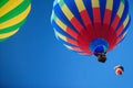 Three hot air balloons at a balloon rally. Royalty Free Stock Photo