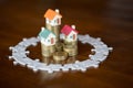 Three house model on stack coins.Jigsaw puzzle, Saving money and property Management concept, investment property, home insurance Royalty Free Stock Photo