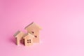 Three houses on a pink background. Buying and selling of real Royalty Free Stock Photo