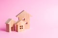 Three houses on a pink background. Buying and selling of real estate, construction. Apartments and apartments. City, settlement. M Royalty Free Stock Photo