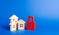 Three houses and a red padlock. Unavailable and expensive real estate. house Insurance. Security and safety. Confiscation