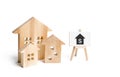 Three houses and a sign on a white background. Buying and selling of real estate, construction. Apartments and apartments.