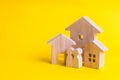 Three houses on a yellow background. Buying and selling of real Royalty Free Stock Photo