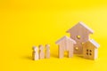 Three houses on a yellow background. Buying and selling of real Royalty Free Stock Photo