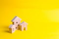 Three houses on a yellow background. Buying and selling of real estate, construction. Apartments and apartments. City, settlement. Royalty Free Stock Photo