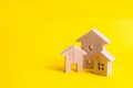 Three houses on a yellow background. Buying and selling of real estate, construction. Apartments and apartments. City, settlement. Royalty Free Stock Photo