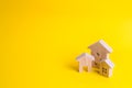 Three houses on a yellow background. Buying and selling of real