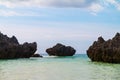 Three huge rocks in the middle of the blue sea ocean Royalty Free Stock Photo