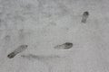 Human Footprints in a Concrete Sidewalk Royalty Free Stock Photo
