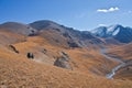 Three hunters on horses in mountains Tien-Shan