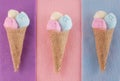 Three ice cream waffle cone shape made out of burlap and cotton balls in pink, yellow and blue Royalty Free Stock Photo